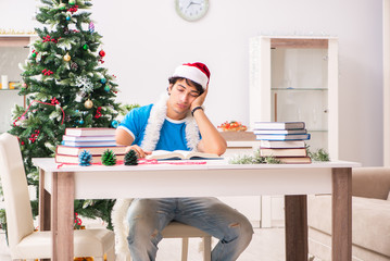 Young student with book at Christmas eve