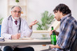 © Elnur - Young male alcoholic visiting old doctor