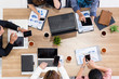 © InfiniteFlow - Top view of businessman executive in group meeting with other businessmen and businesswomen in modern office with laptop computer, coffee and document on table. People corporate business team concept.