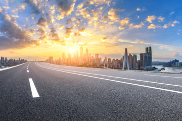 Asphalt highway and modern city financial district skyline in Chongqing at sunset,China.