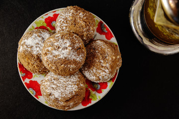 Delicious pastry on a dark background in white crockery and tea