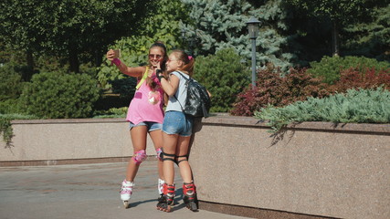 Girls rollerblading take a selfie on a smartphone