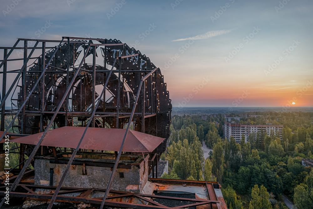 Soviet Union iron coat of arms in the dawn rays on the roof of a multi ...