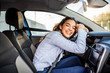 © Dragana Gordic - Young and cheerful woman enjoying new car hugging steering wheel sitting inside. Woman driving a new car. Woman Driver Portrait at Car