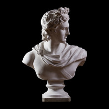 Statue. On A Black Isolated Background. Gypsum Statue Of Apollo's Bust. Man.