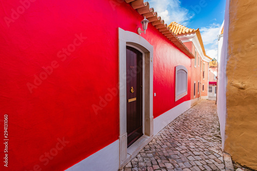 old-narrow-street-with-red-house-in-cascais-portugal