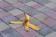 © OlegD - Banana peel was left on the pavement. The danger may slip. If anyone walks on it. Be careful of slippery. Closeup, outdoors
