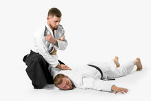 Two Caucasian Men Are Practicing Aikido On The Tatami (isolation Path Included)