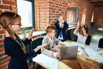 Wall Mural - Cheerful businesschildren applauding in a meeting. Business concept.close up photo. happiness, celebration