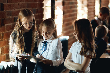 Wall Mural - motivated business girls sharing with ideas, plans in the office with loft interior, close up photo. education