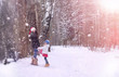 © alexkich - A winter fairy tale,in the forest. A girl on a sled with gifts on the eve of the new year in the park. Two sisters walk in a New Year's park and ride a sled with gifts.