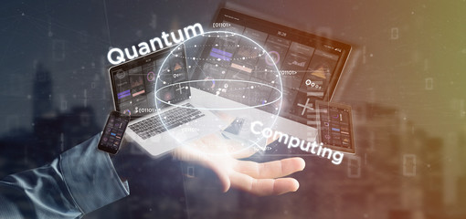 Wall Mural - businessman holding quantum computing concept with qubit and devices 3d rendering