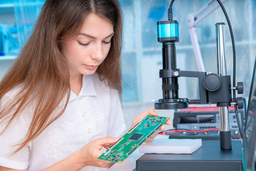 Wall Mural - Young woman in inspection electronics PCB devise. Modern electronics laboratory