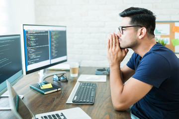 Wall Mural - attractive latin computer science freelancer looking at screens