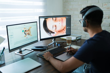 Wall Mural - Young Freelancer Retouching While Working At Home