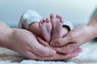 © Tomas Auer - Mother and father hold the baby's feet, Newborn Baby's feet ,Tiny feet in hand.
