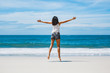 © Peera - Happy asian woman jumping on beach