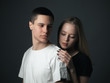 © Dima Aslanian - Young gentle couple in love posing in studio.