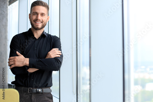 Cuadros en Lienzo Modern business man is standing near window in the office