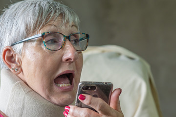 older woman with glasses talking on the phone scared and asking for help , abuse concept