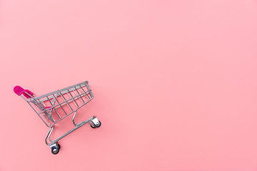 empty shopping cart on pink background. shopping, shopping online concept.,copy space, top view