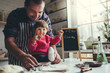 © MarkoVS87 - Happy family in the kitchen. Father and daughter are preparing the christmas cookies.
