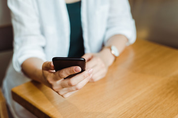 Close up woman hand using smartphone, downloading mobile application for online shopping with discount sales, mobile banking. Female blog post, reading news. Business woman chatting in phone