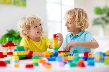 Wall Mural - Child playing with toy blocks. Toys for kids.