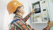 © procinemastock - Young adult electrician builder engineer checking equipment in fuse box