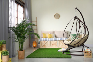 Stylish modern room interior with swing chair