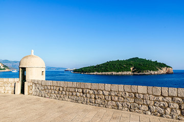 Wall Mural - Gun turret on old city walls of Dubrovnik with Lokrum in background