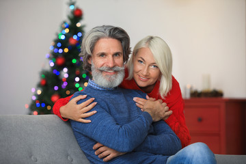 Wall Mural - Happy mature couple celebrating Christmas at home