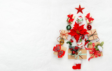 Wall Mural - Christmas tree made from Christmas gifts and decorations on white background. Creative winter holiday concept. Flat lay.