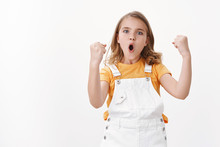 Amused Cheerful Young Blond Girl Child, Celebrating Victory, Feeling Excited Like Winner, Fist Pump Triumphing, Say Yes Hooray, Pouting Proudly, Stand White Background Enthusiastic