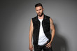 © Viorel Sima - Determined casual man posing and wearing a black jeans vest