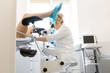 A gynecologist is examined by a patient who is sitting in a gynecological chair. Examination by a gynecologist. Female health concept