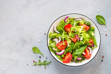 Green Salad From Fresh Leaves And Tomatoes.