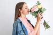 © Pixel-Shot - Beautiful young woman with bouquet of carnation flowers on light background