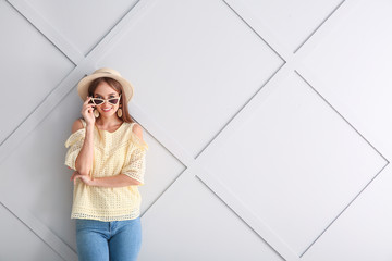 Wall Mural - Beautiful young woman on light background