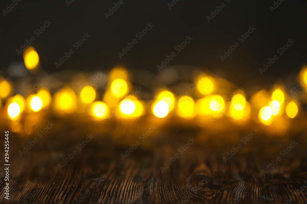 Closeup view of wooden table with blurred lights