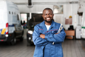 Wall Mural - African-American mechanic in car service center