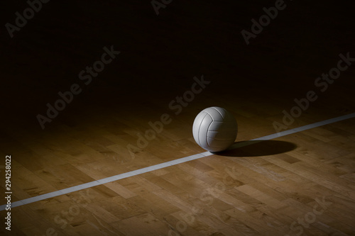 Photographie Volleyball court wooden floor with ball on black with copy-space