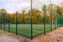 Mini-football Court Fenced With A Green Fence In Autumn Day