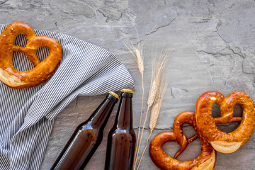 Wall Mural - Octoberfest background. Pretzels and beer on grey background top view copy space