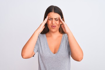 Portrait of beautiful young woman standing over isolated white background with hand on head for pain in head because stress. Suffering migraine.