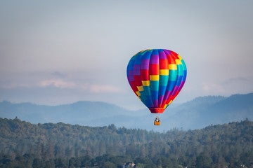 colorful hot air balloon over grants pass oregon on a beautiful summer morning