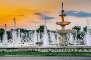 Fountains with sunset at Unirii Square in Bucharest, Romania