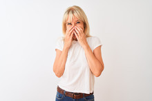 Middle Age Woman Wearing Casual T-shirt Standing Over Isolated White Background Laughing And Embarrassed Giggle Covering Mouth With Hands, Gossip And Scandal Concept