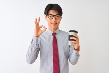 Poster - Chinese businessman wearing tie and glasses drinking coffee over isolated white background doing ok sign with fingers, excellent symbol