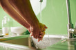 © DragonImages - Close-up image of man rinsing hands under tap water before cooking dinner